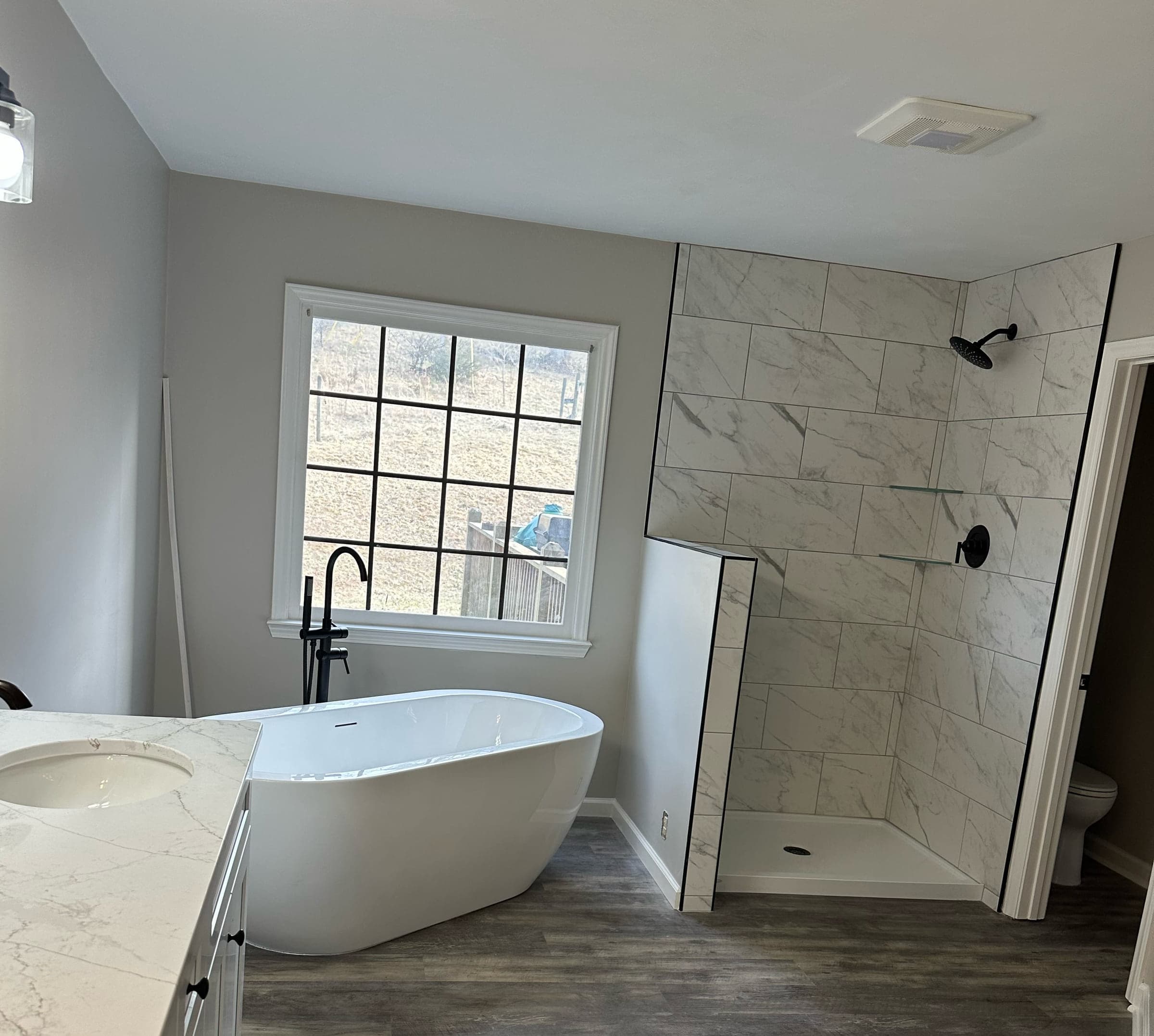 Fincastle Custom Bathroom in Botetourt County after a full remodel, with a new soaking tub, tiled shower, double vanity, fixtures and flooring